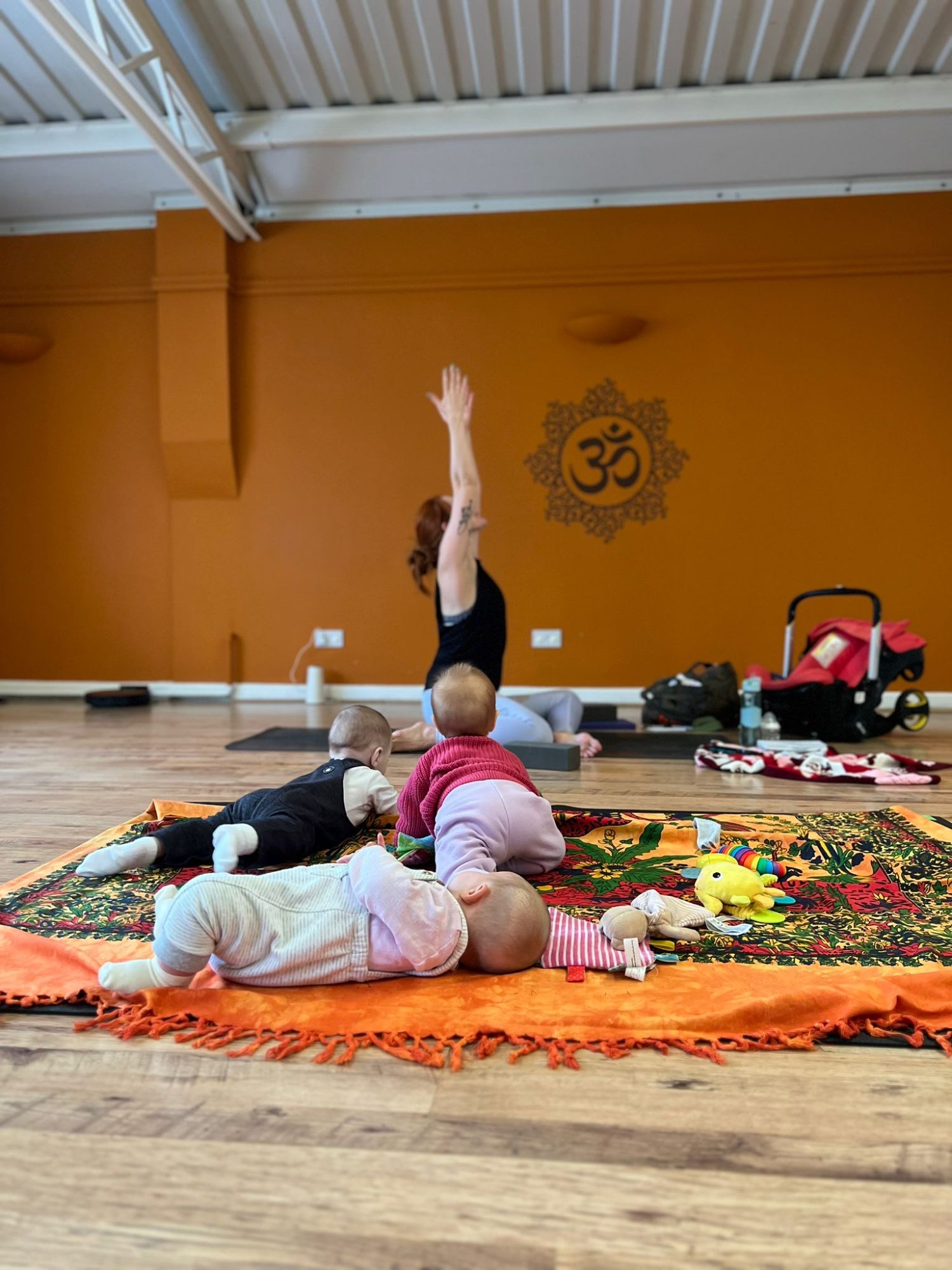 Sophia teaching with babies at the front of a Yogi & Bear class